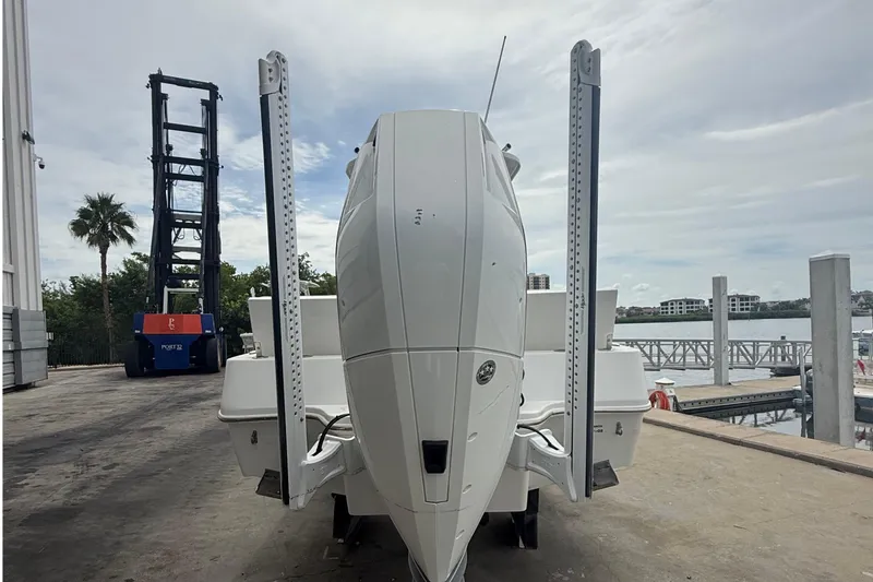 Slide: The Image of 2023 Tides 26 boat at dockside with marina view in background. - 26