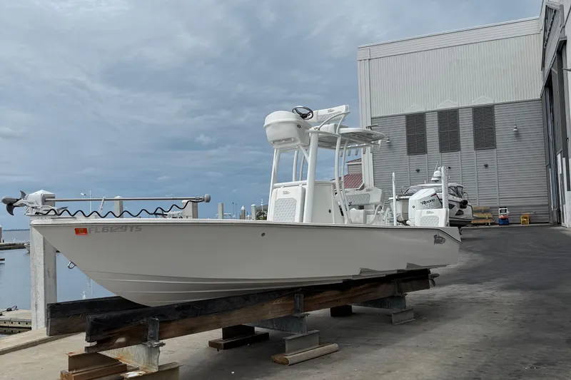 Slide: The Image of 2023 Tides 26 boat on dock, ready for launch under cloudy sky. - 30