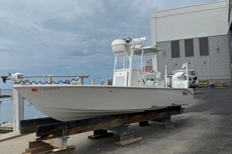 Slide: The Image of 2023 Tides 26 boat on dock, marina background, overcast sky. - 31
