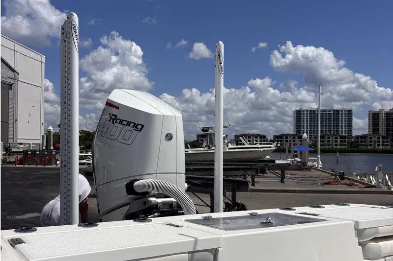 Slide: The Image of 2023 Tides 26 boat with powerful outboard motor at marina under blue sky. - 7