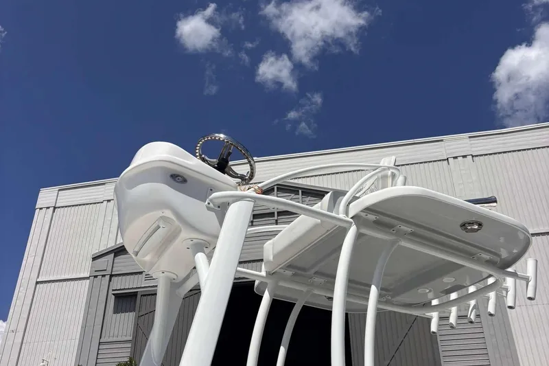 Slide: The Image of 2023 Tides 26 boat tower against blue sky and industrial building backdrop. - 8