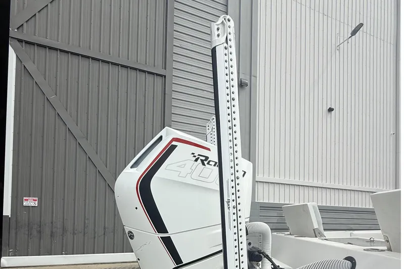 Slide: The Image of 2023 Tides 26 boat with powerful engine near industrial building. - 9