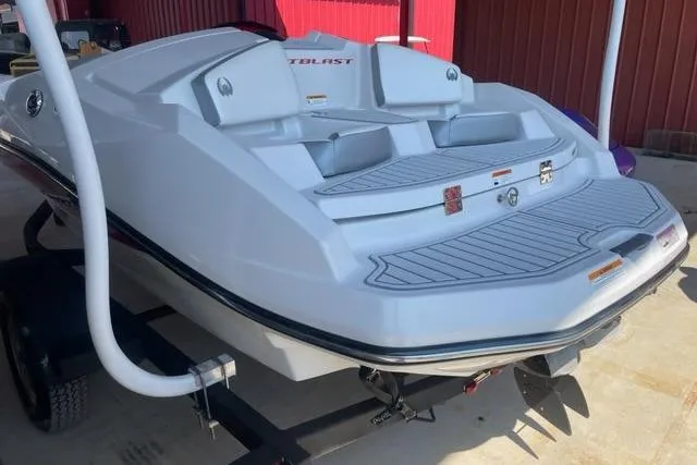Slide: The Image of 2016 Scarab 165 G boat on trailer, rear view, white hull, outdoor setting. - 4