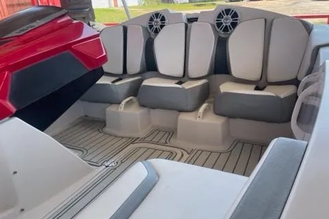 Slide: The Image of 2016 Scarab 165 G boat interior with gray and white seating and speakers. - 6