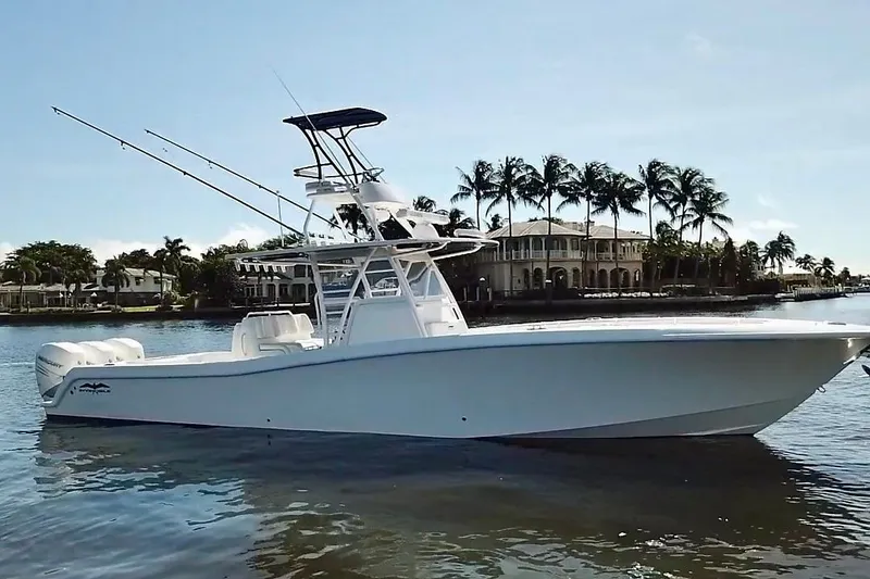 The Image of 2020 Invincible 39 Open Fisherman boat on calm water, with palm trees in the background. - 1