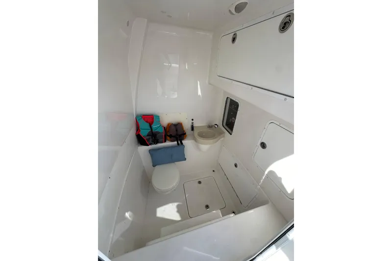 Slide: The Image of 2020 Invincible 39 Open Fisherman boat interior with toilet and storage compartments. - 13
