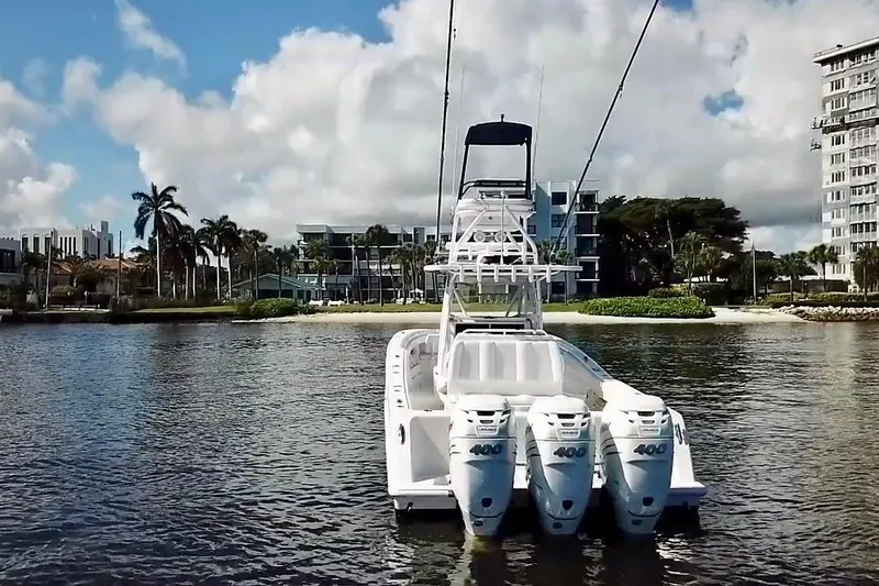 Slide: The Image of 2020 Invincible 39 Open Fisherman boat with triple engines on calm water. - 4