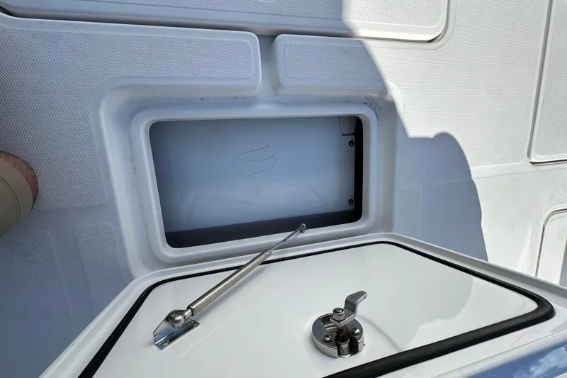 Slide: The Image of 2020 Invincible 39 Open Fisherman boat storage compartment with latch and hydraulic support. - 9
