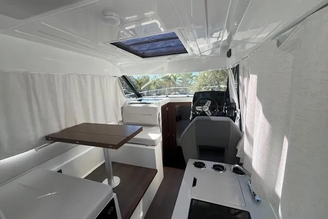 Slide: The Image of Interior of 2026 Beneteau Antares 9 V2, featuring modern seating and helm station. - 20