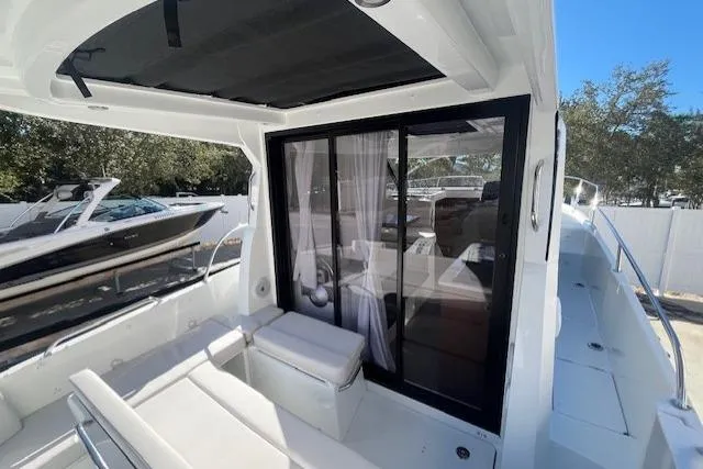 Slide: The Image of 2026 Beneteau Antares 9 V2 boat interior with sliding glass door and seating area. - 22