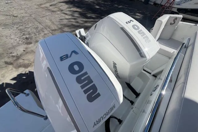 Slide: The Image of 2026 Beneteau Antares 9 V2 with dual Mercury outboard engines, docked in sunlight. - 25