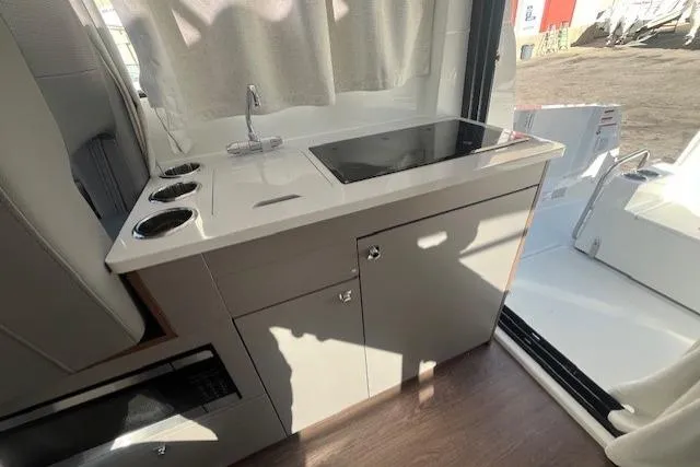 Slide: The Image of 2026 Beneteau Antares 9 V2 interior kitchen with stove and sink. - 7