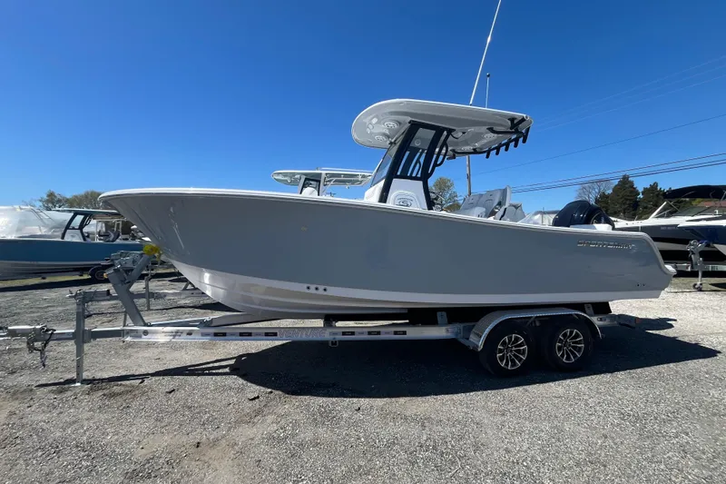 The Image of 2026 Sportsman Heritage 231 Center Console boat on trailer, side view. - 10