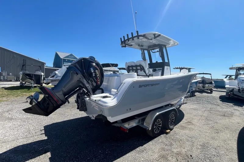 Slide: The Image of 2026 Sportsman Heritage 231 Center Console boat on trailer, sunny day. - 12