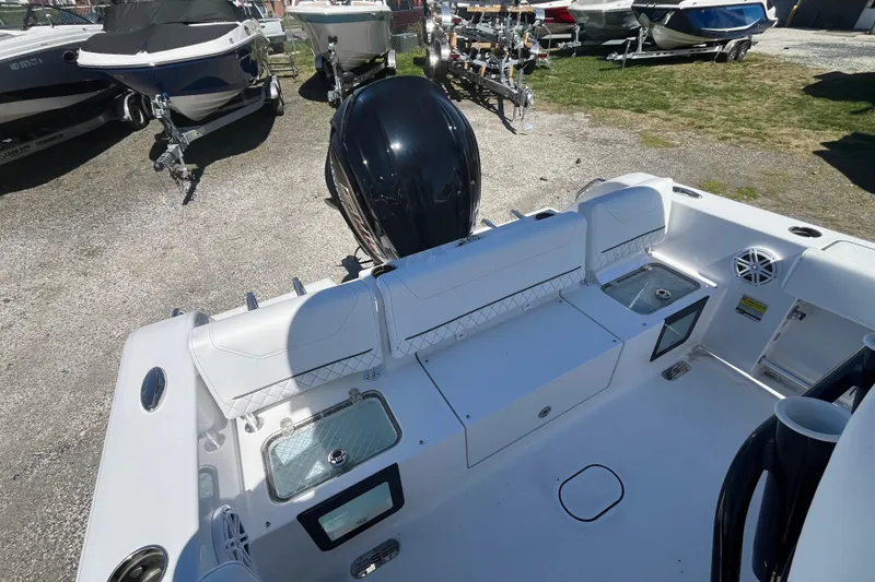 Slide: The Image of 2026 Sportsman Heritage 231 Center Console boat interior with seating and storage. - 14