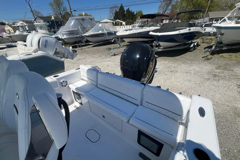 Slide: The Image of 2026 Sportsman Heritage 231 Center Console boat with sleek seating and powerful outboard motor. - 20