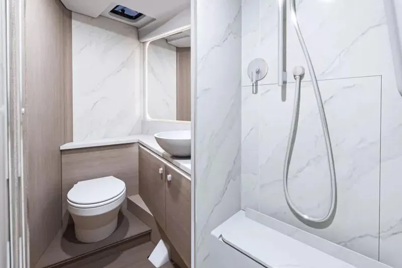 Slide: The Image of 2026 Beneteau Gran Turismo 40 yacht cruising near a scenic coastline. - 8