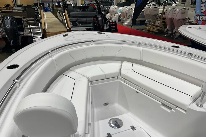 Slide: The Image of 2026 Sportsman Heritage 231 Center Console boat interior with white cushioned seating. - 12
