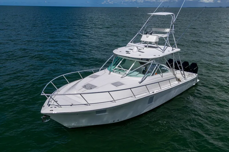 Slide: The Image of 2014 SeaVee 430 boat on open water, featuring sleek design and multiple outboard engines. - 10