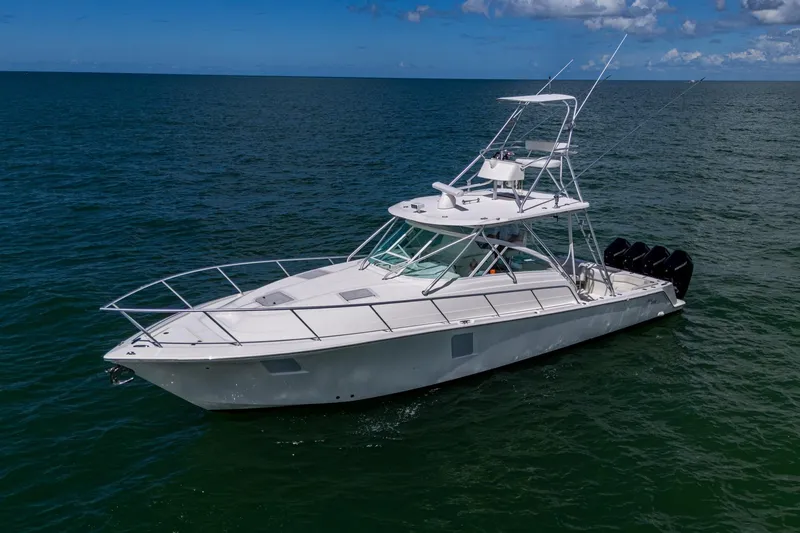 Slide: The Image of 2014 SeaVee 430 boat cruising on open water under a clear blue sky. - 11