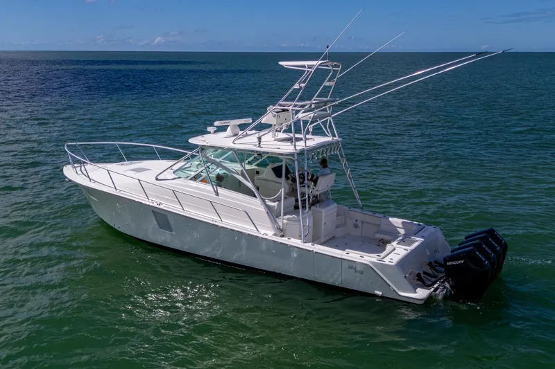 Slide: The Image of 2014 SeaVee 430 boat on open water, featuring multiple outboard engines. - 12