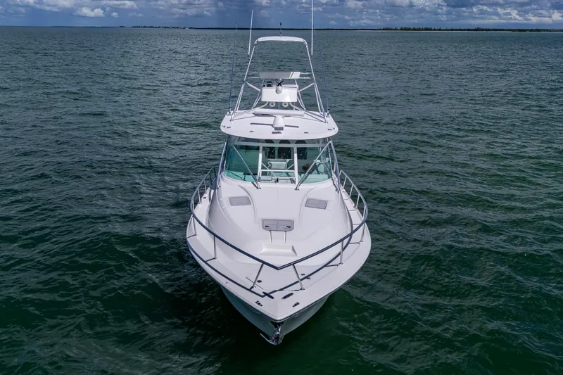 Slide: The Image of 2014 SeaVee 430 boat on open water under cloudy sky. - 13