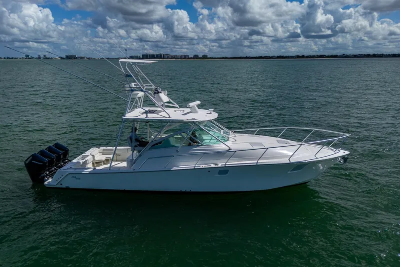 Slide: The Image of 2014 SeaVee 430 boat on calm water under a partly cloudy sky. - 14