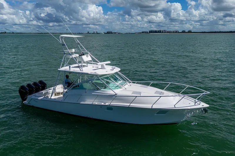 Slide: The Image of 2014 SeaVee 430 boat on open water under cloudy sky. - 15