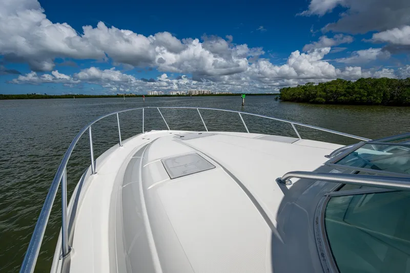 Slide: The Image of 2014 SeaVee 430 boat cruising on a sunny day with scenic waterway views. - 20