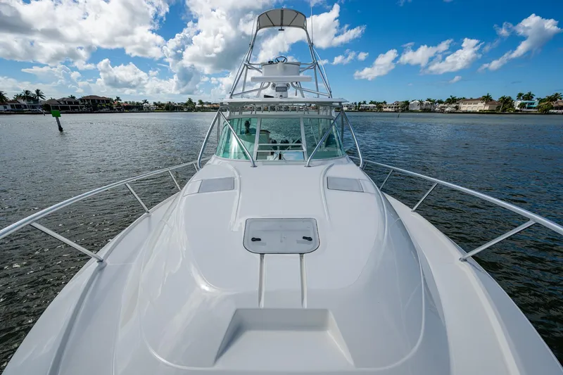 Slide: The Image of 2014 SeaVee 430 boat on calm water under a blue sky with clouds. - 23