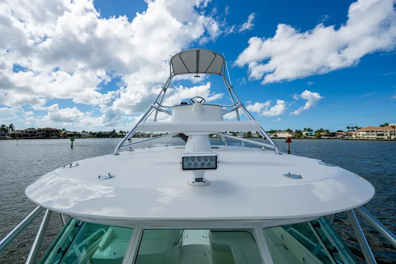 Slide: The Image of 2014 SeaVee 430 boat on water under blue sky with clouds. - 24