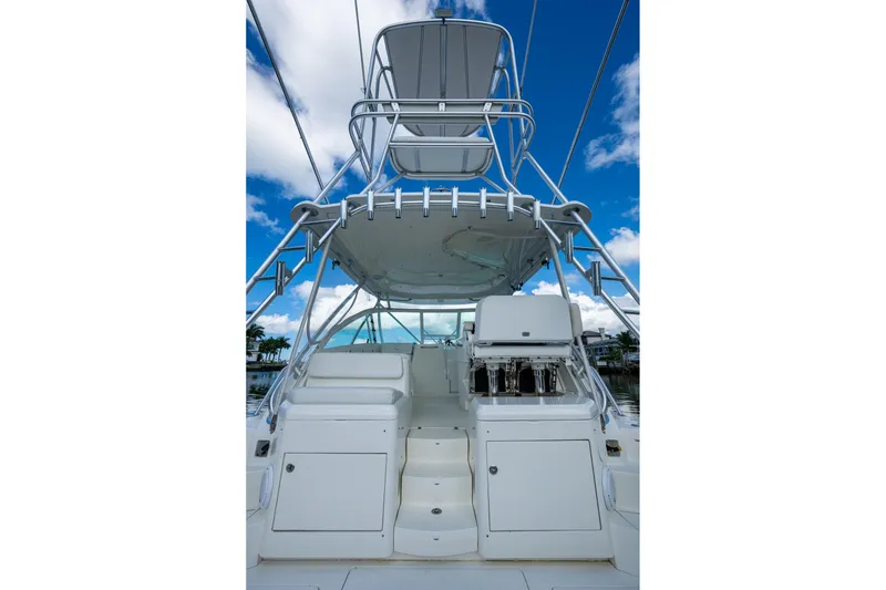 Slide: The Image of 2014 SeaVee 430 boat with tower, white deck, and clear blue sky background. - 25