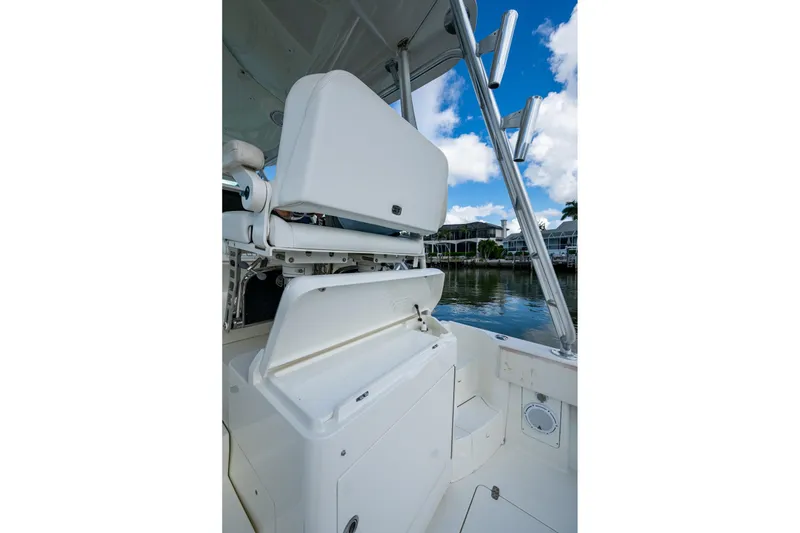 Slide: The Image of 2014 SeaVee 430 boat interior with open storage compartments and rod holders. - 28