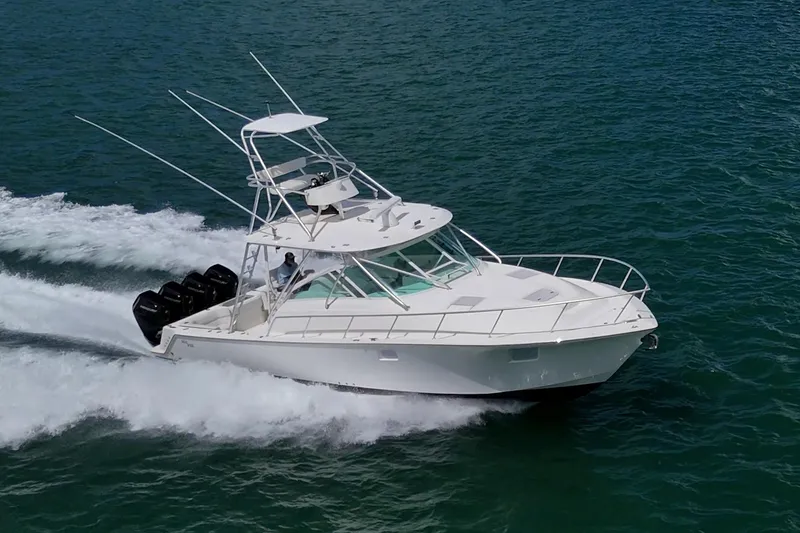 Slide: The Image of 2014 SeaVee 430 boat cruising on open water with multiple outboard engines. - 3