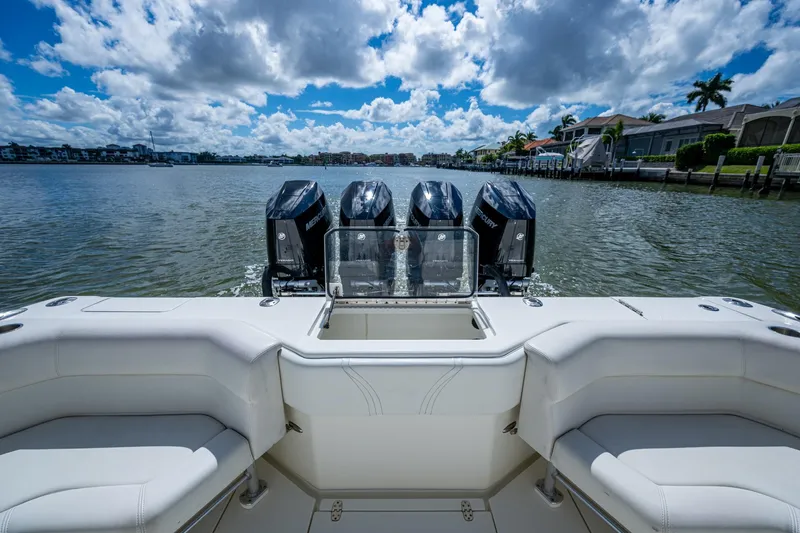 Slide: The Image of 2014 SeaVee 430 boat with four powerful outboard engines on a sunny day. - 30