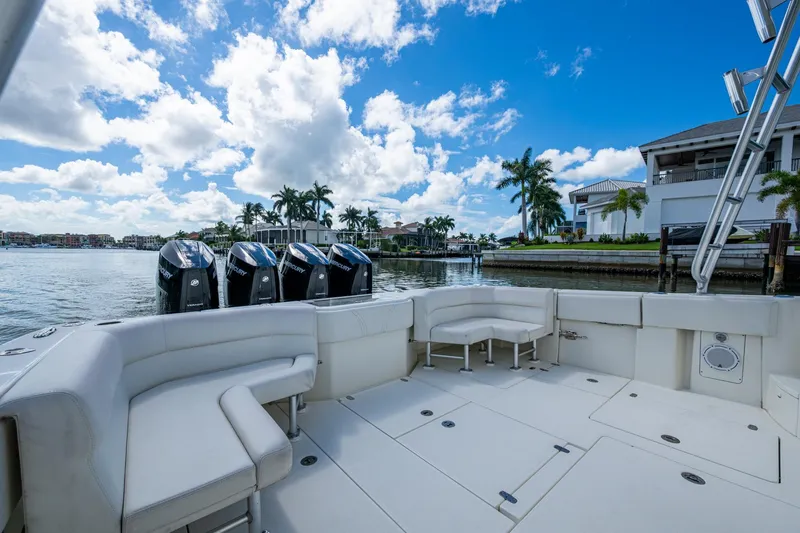 Slide: The Image of 2014 SeaVee 430 boat with multiple outboard engines, docked near waterfront homes. - 31