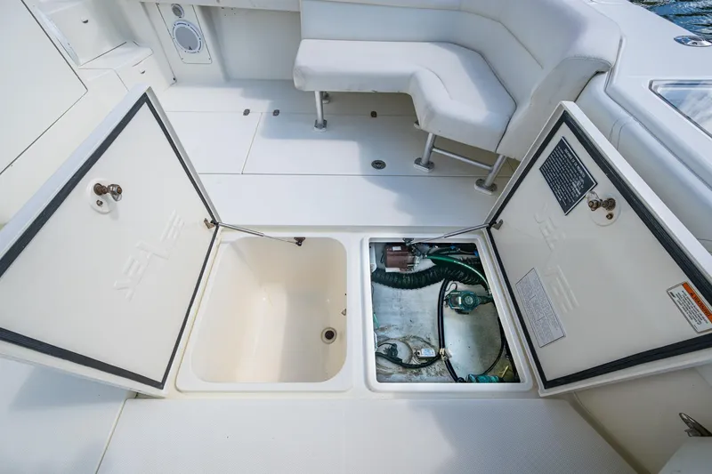 Slide: The Image of 2014 SeaVee 430 boat deck with open storage compartments and seating area. - 34