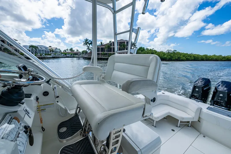Slide: The Image of 2014 SeaVee 430 boat interior with helm seat, steering wheel, and outboard motors. - 41
