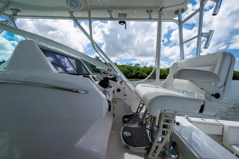 Slide: The Image of Interior view of 2014 SeaVee 430 boat cockpit with white seating and controls. - 42