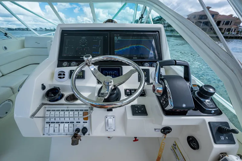 Slide: The Image of 2014 SeaVee 430 boat helm with advanced navigation and control systems. - 44