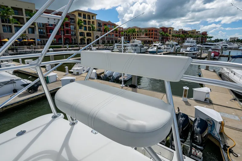Slide: The Image of 2014 SeaVee 430 boat seat overlooking marina with colorful buildings and cloudy sky. - 49