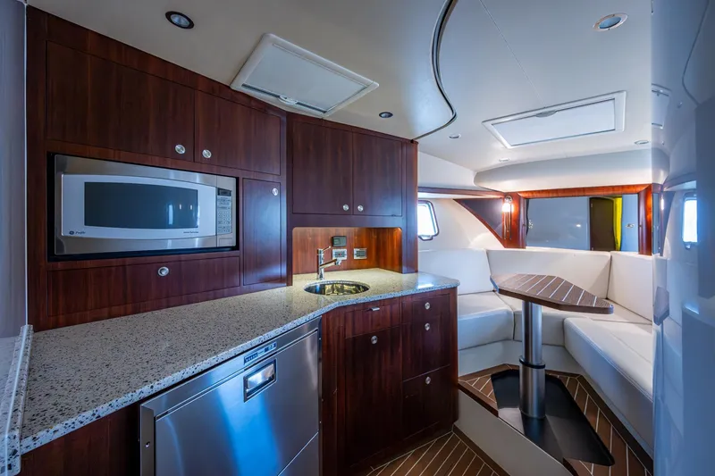 Slide: The Image of Luxurious 2014 SeaVee 430 yacht interior with modern kitchen and cozy seating area. - 52