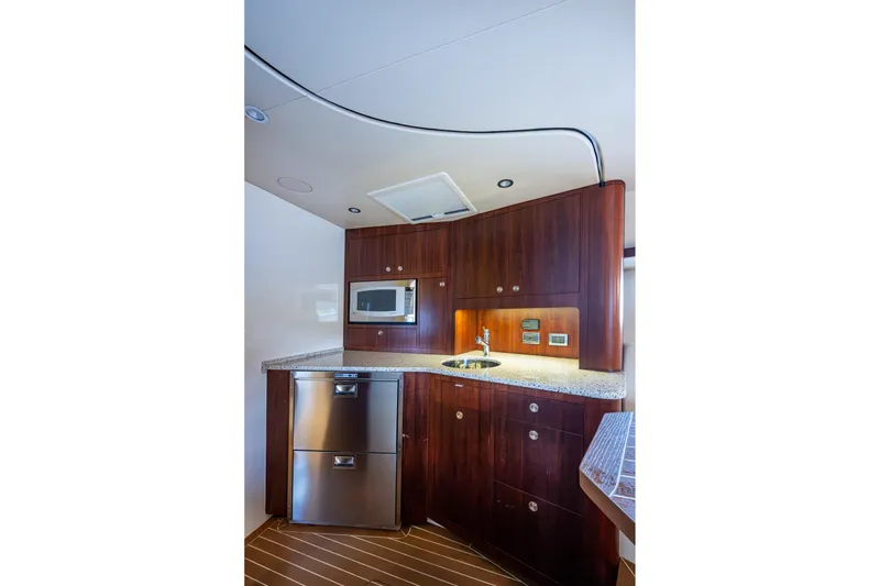 Slide: The Image of Luxurious 2014 SeaVee 430 yacht kitchen with wood cabinetry and modern appliances. - 53