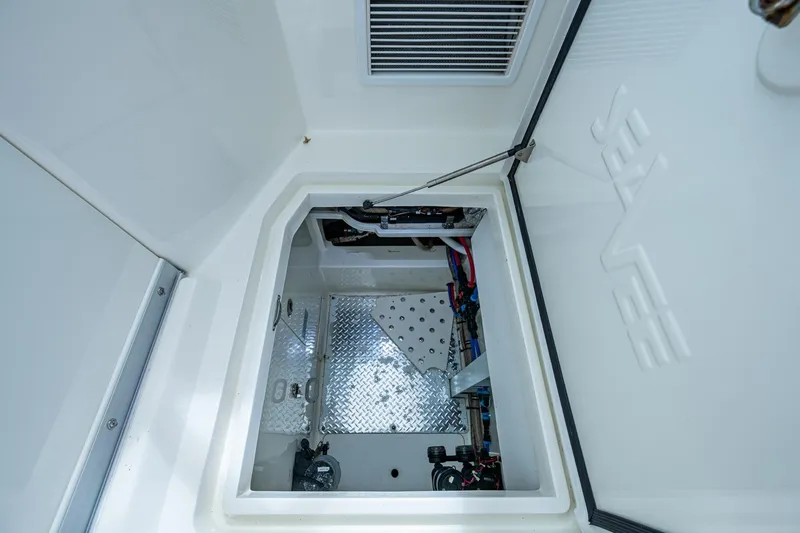 Slide: The Image of 2014 SeaVee 430 boat interior compartment with open hatch and visible wiring. - 63