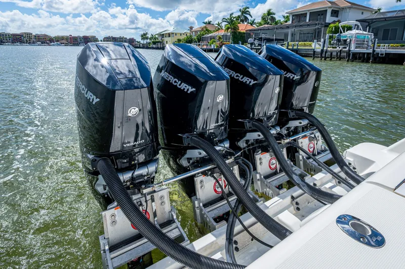 Slide: The Image of Four Mercury Verado outboard engines on a 2014 SeaVee 430 boat, docked by waterfront homes. - 65