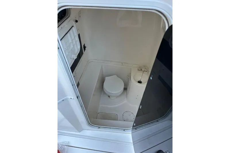 Slide: The Image of 2006 Fountain 38 Tournament Edition boat interior with compact marine toilet. - 13