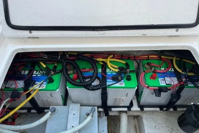 Slide: The Image of Battery compartment of a 2006 Fountain 38 Tournament Edition boat with multiple connected batteries. - 16