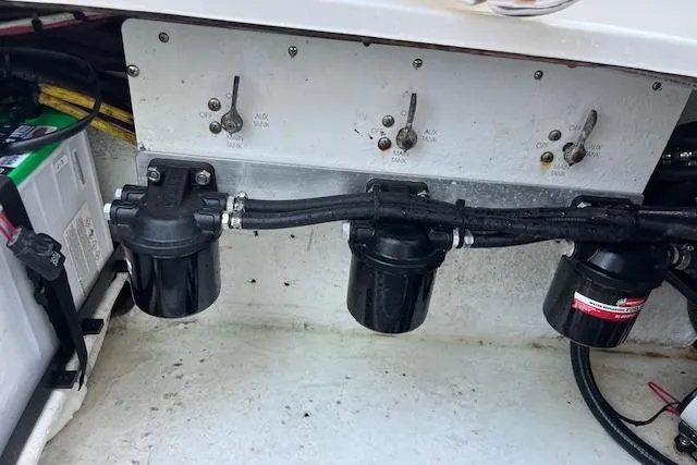 Slide: The Image of Engine compartment of 2006 Fountain 38 Tournament Edition boat, showing fuel filters and switches. - 17