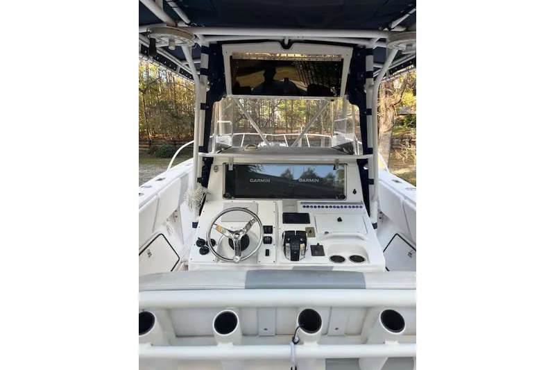 Slide: The Image of 2006 Fountain 38 Tournament Edition boat cockpit with steering wheel and Garmin navigation system. - 4