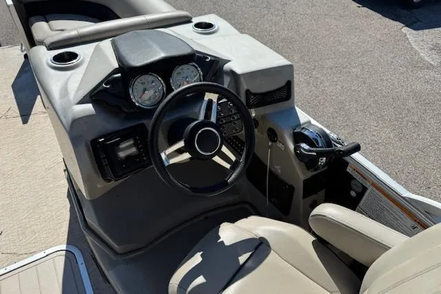 Slide: The Image of 2019 Barletta E22Q SS boat dashboard with steering wheel and controls. - 3